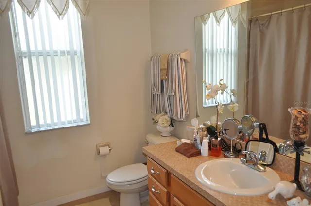 a bathroom with a sink toilet and mirror