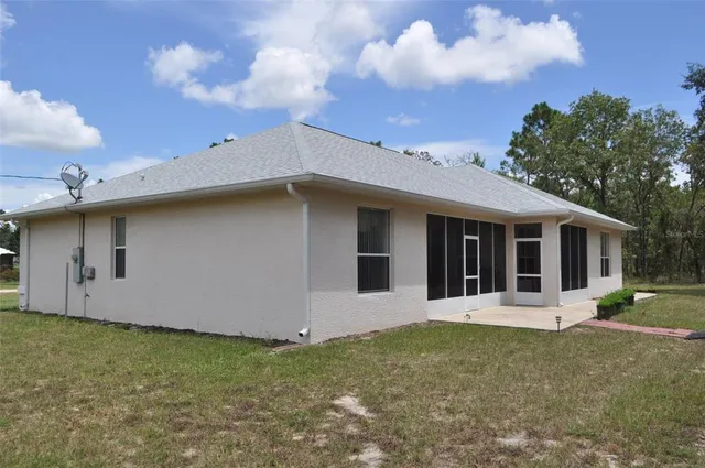 a view of a house with backyard porch and garden