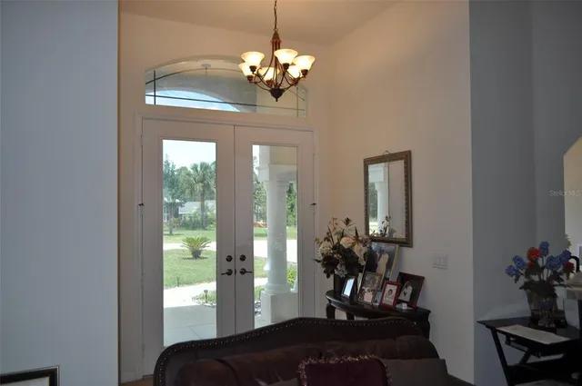 a view of a dining room with a chandelier and living room