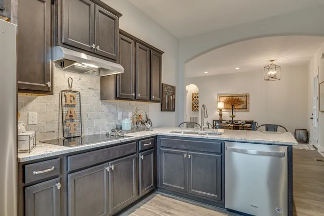 a kitchen with a sink cabinets and stainless steel appliances