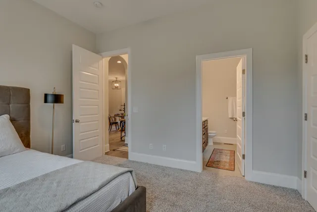 a bedroom with a bed and a mirror