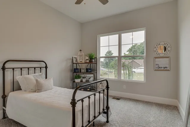a bedroom with furniture and a window