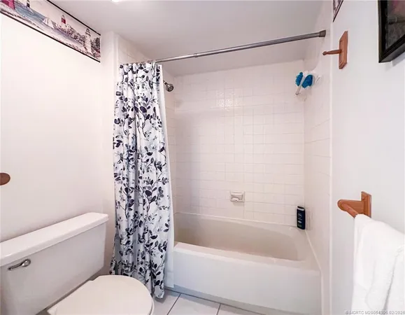 a bathroom with a shower curtain and a toilet