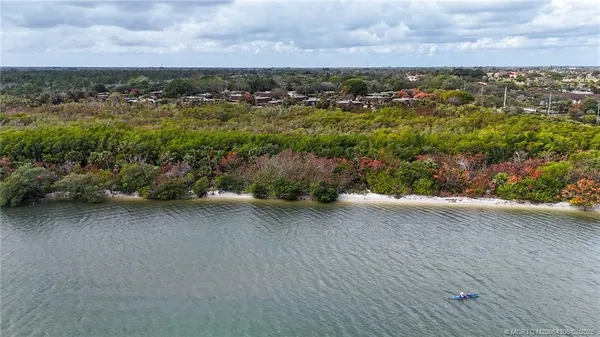 an aerial view of a houses with city view
