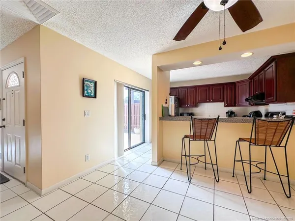 a view of kitchen with furniture and refrigerator
