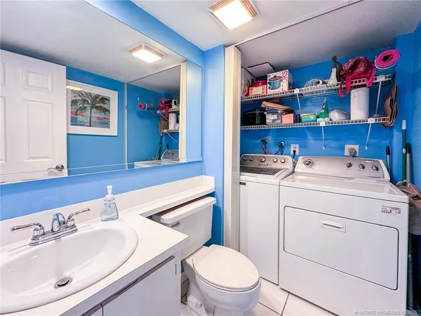 a bathroom with a sink toilet and a mirror