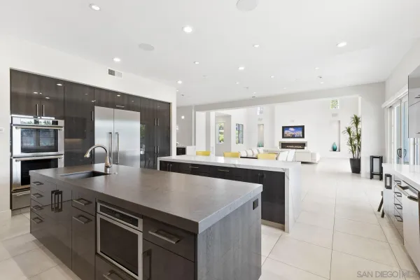 a large kitchen with stainless steel appliances a lot of counter space and a sink