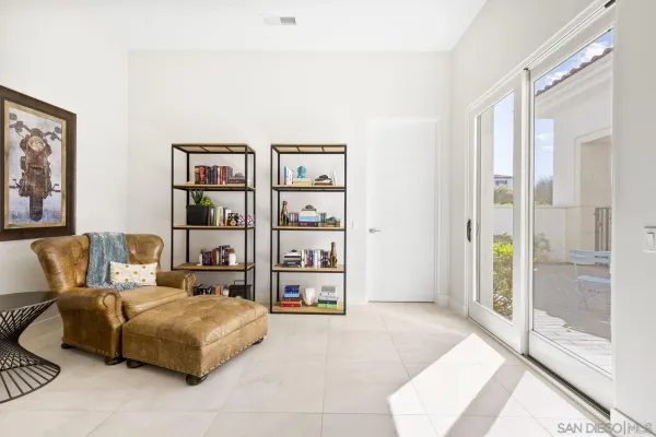 a living room with furniture cabinets and window