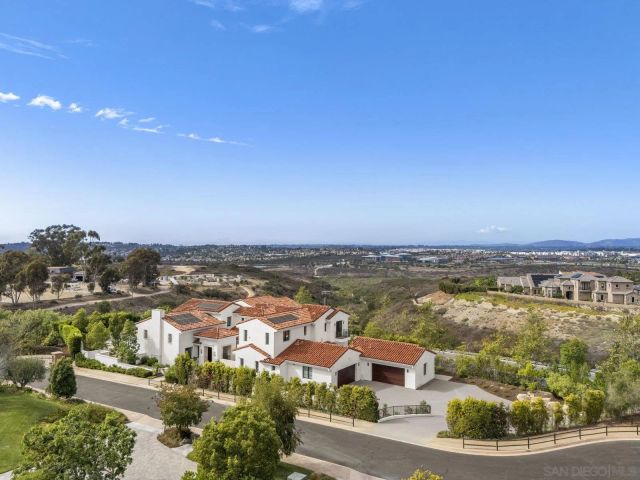 an aerial view of residential houses with outdoor space and river