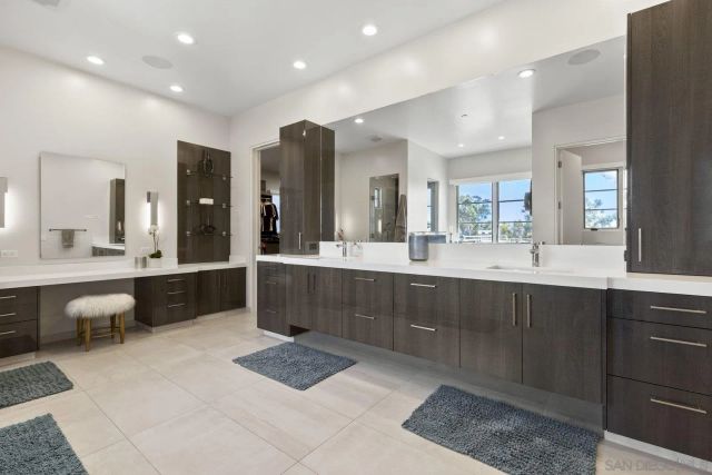 a spacious bathroom with a tub sink and mirror