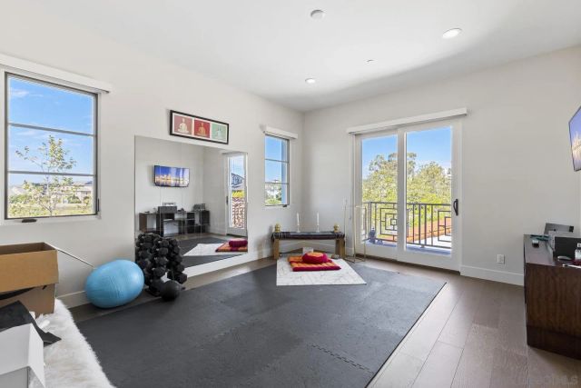 a spacious bedroom with a bed and a large window