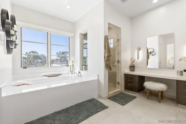 a bedroom with furniture and a large window