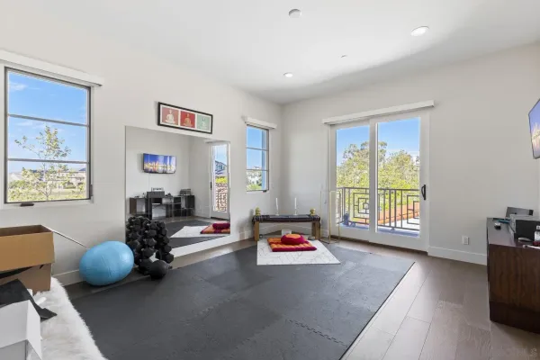 a spacious bedroom with a bed and a large window