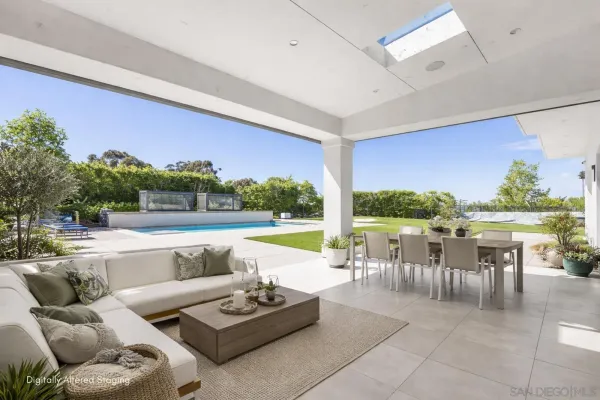 a swimming pool with outdoor seating and yard