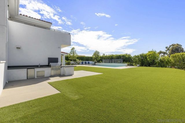 an aerial view of a house with a garden and lake view