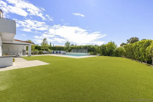 a view of a house with swimming pool and a yard