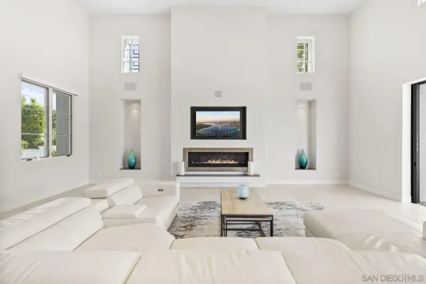 a spacious bedroom with a bed a couch and a window