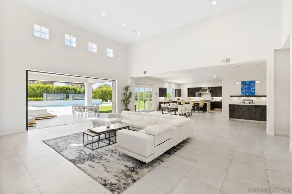 a living room with furniture large window and a table