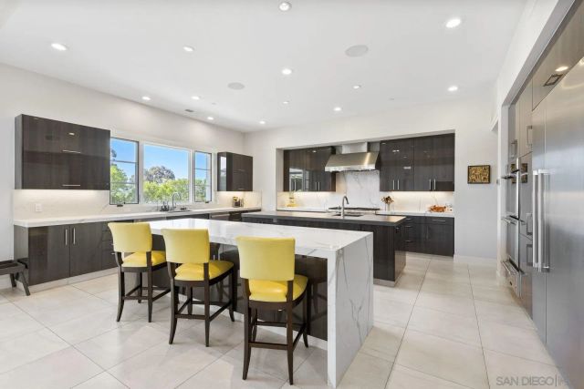 a kitchen with a table and chairs in it