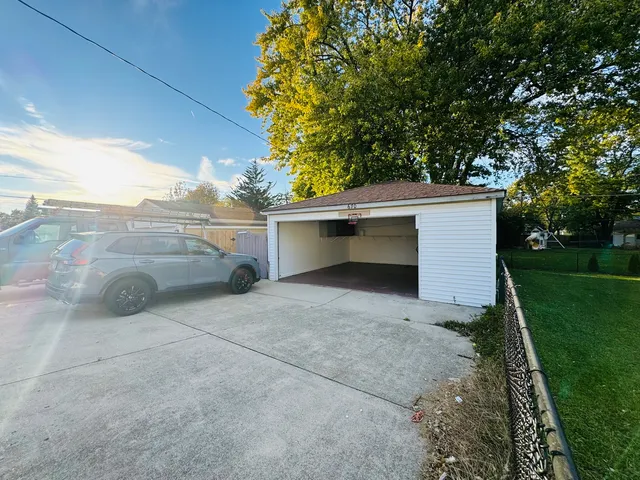 a view of a house with a yard and garage