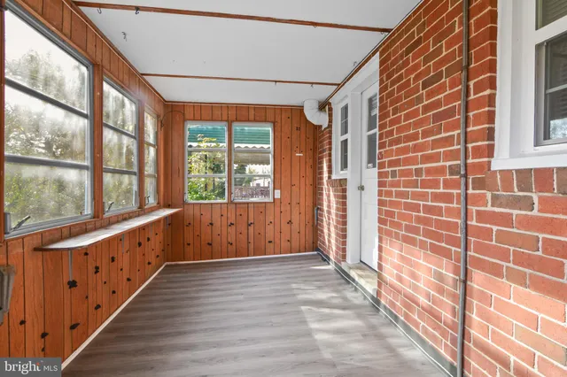 a view of an entryway with wooden floor and windows