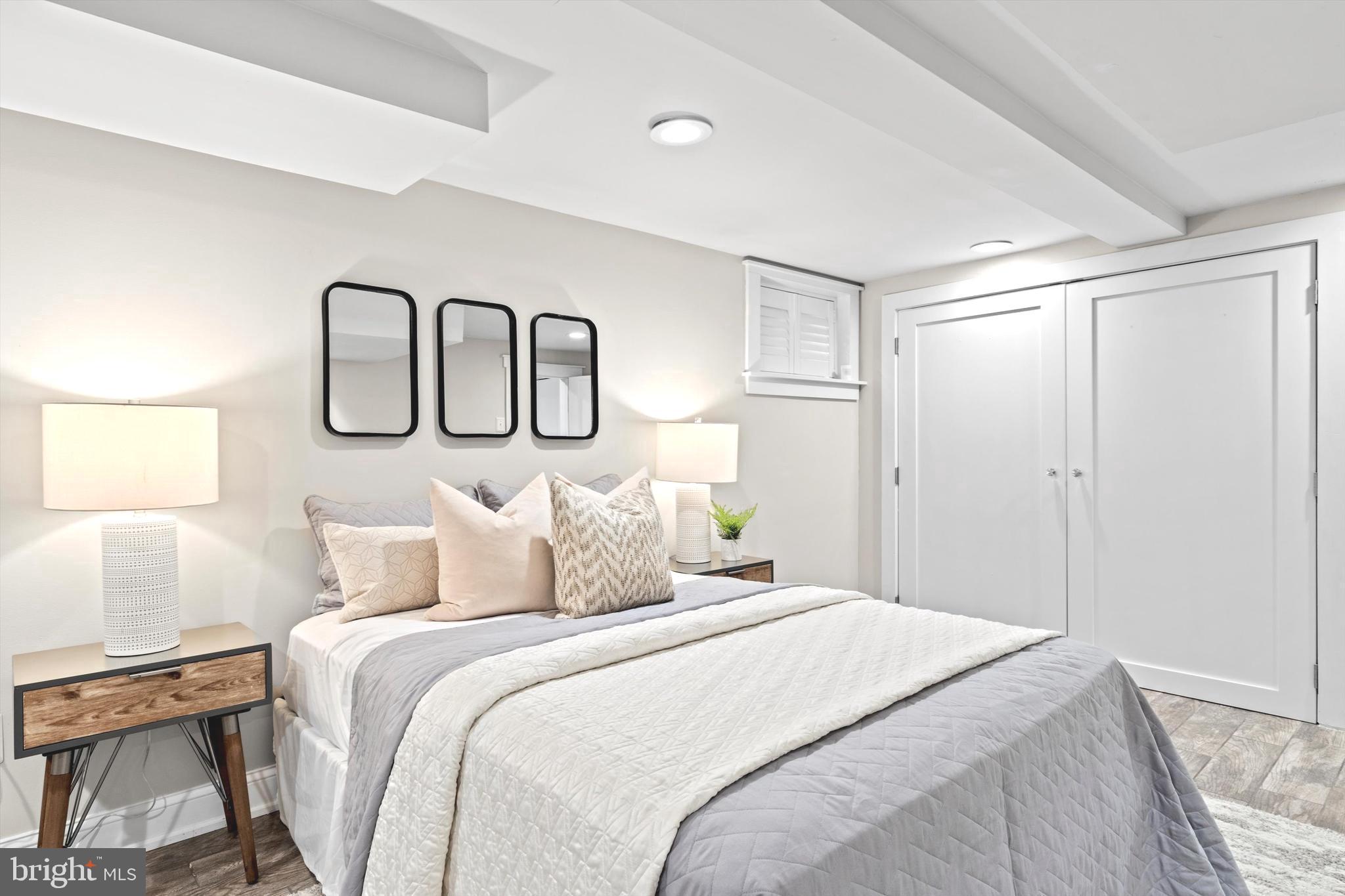 6118 Sligo Mill Road Northeast Washington, DC 20011 - Photo 18 of 28 a bedroom with a large bed and two lamp
