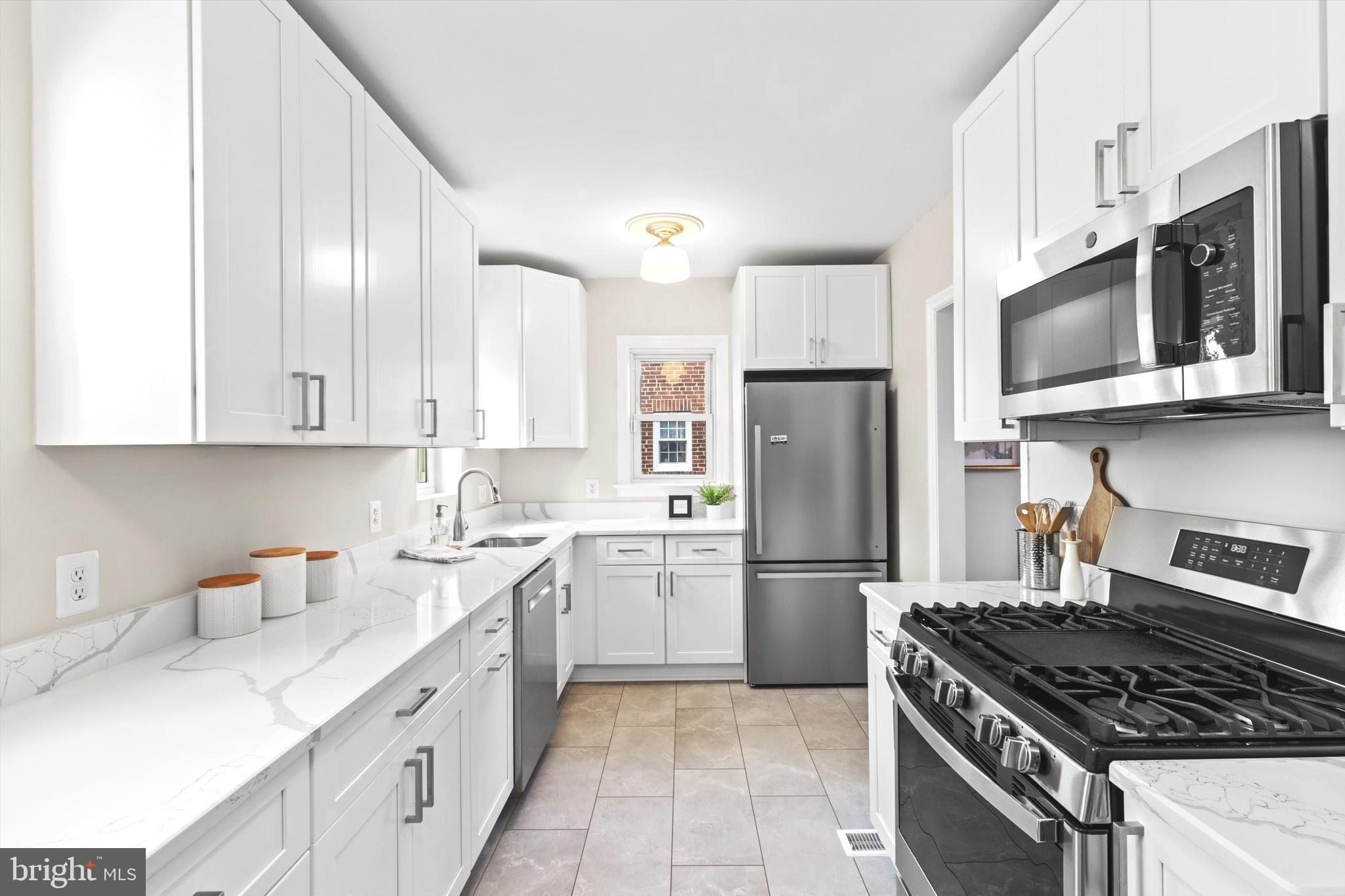 6118 Sligo Mill Road Northeast Washington, DC 20011 - Photo 3 of 28 a kitchen with stainless steel appliances granite countertop a stove a refrigerator and a microwave