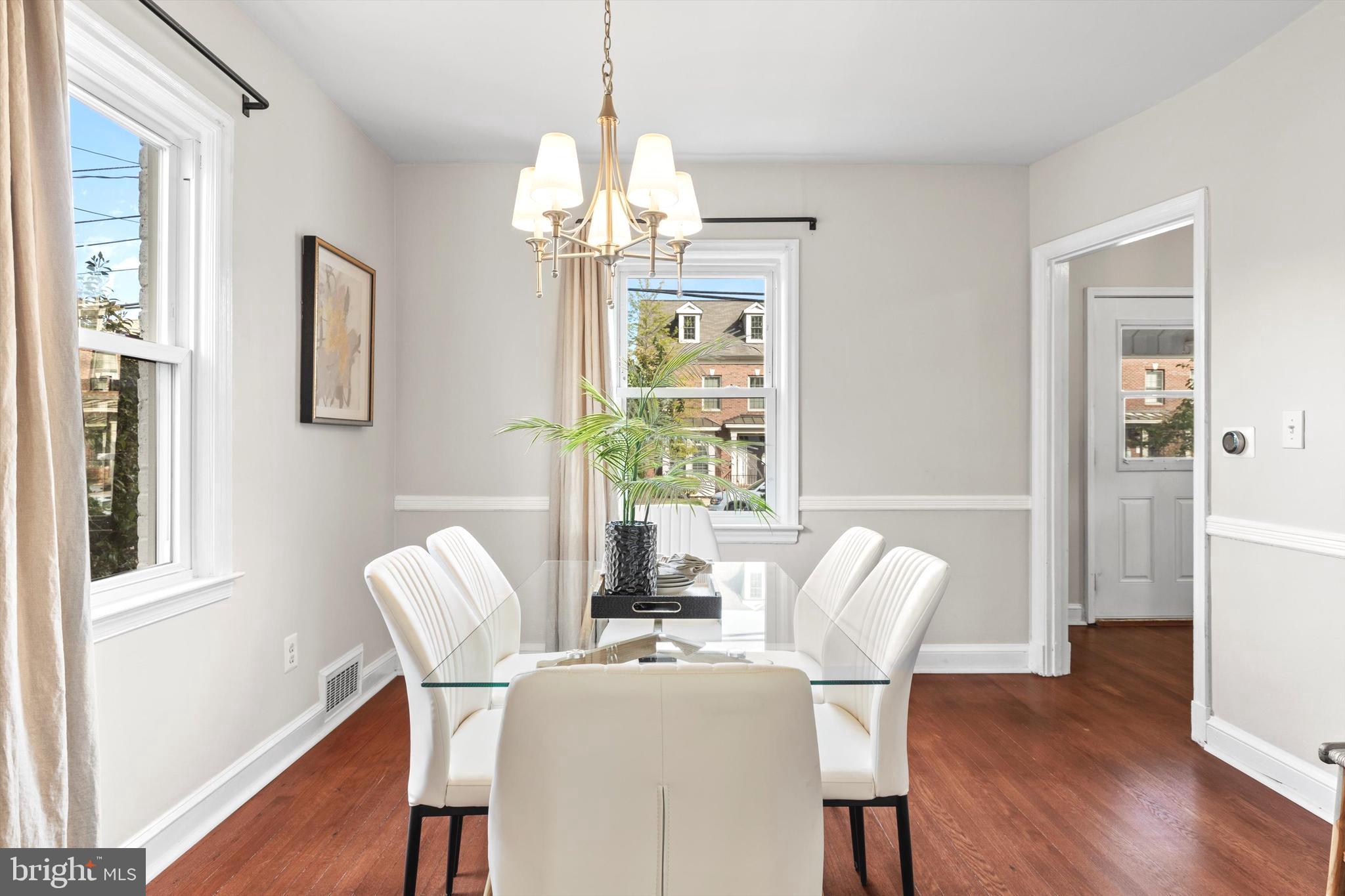 6118 Sligo Mill Road Northeast Washington, DC 20011 - Photo 7 of 28 a dining room with furniture a chandelier and wooden floor