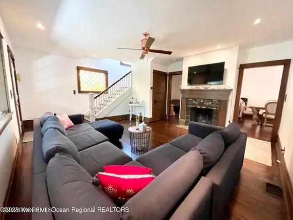 a living room with furniture a flat screen tv and a fireplace