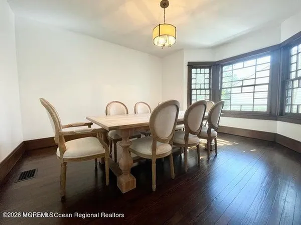 a dining room with furniture and wooden floor
