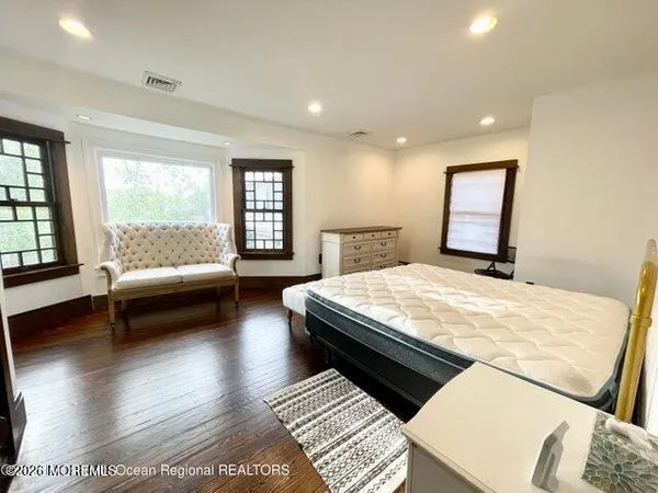 a bedroom with a bed and glass window