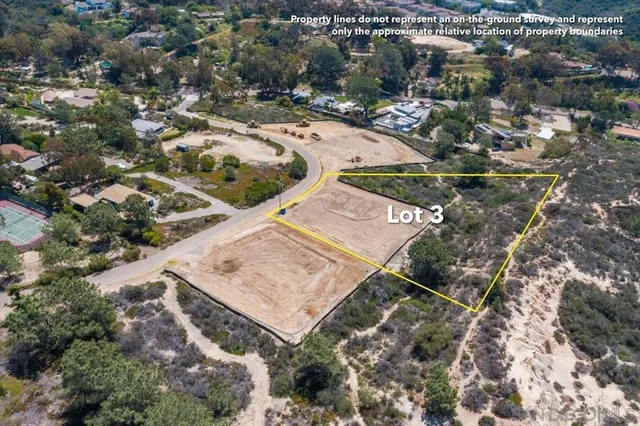 an aerial view of a house with a yard and mountain