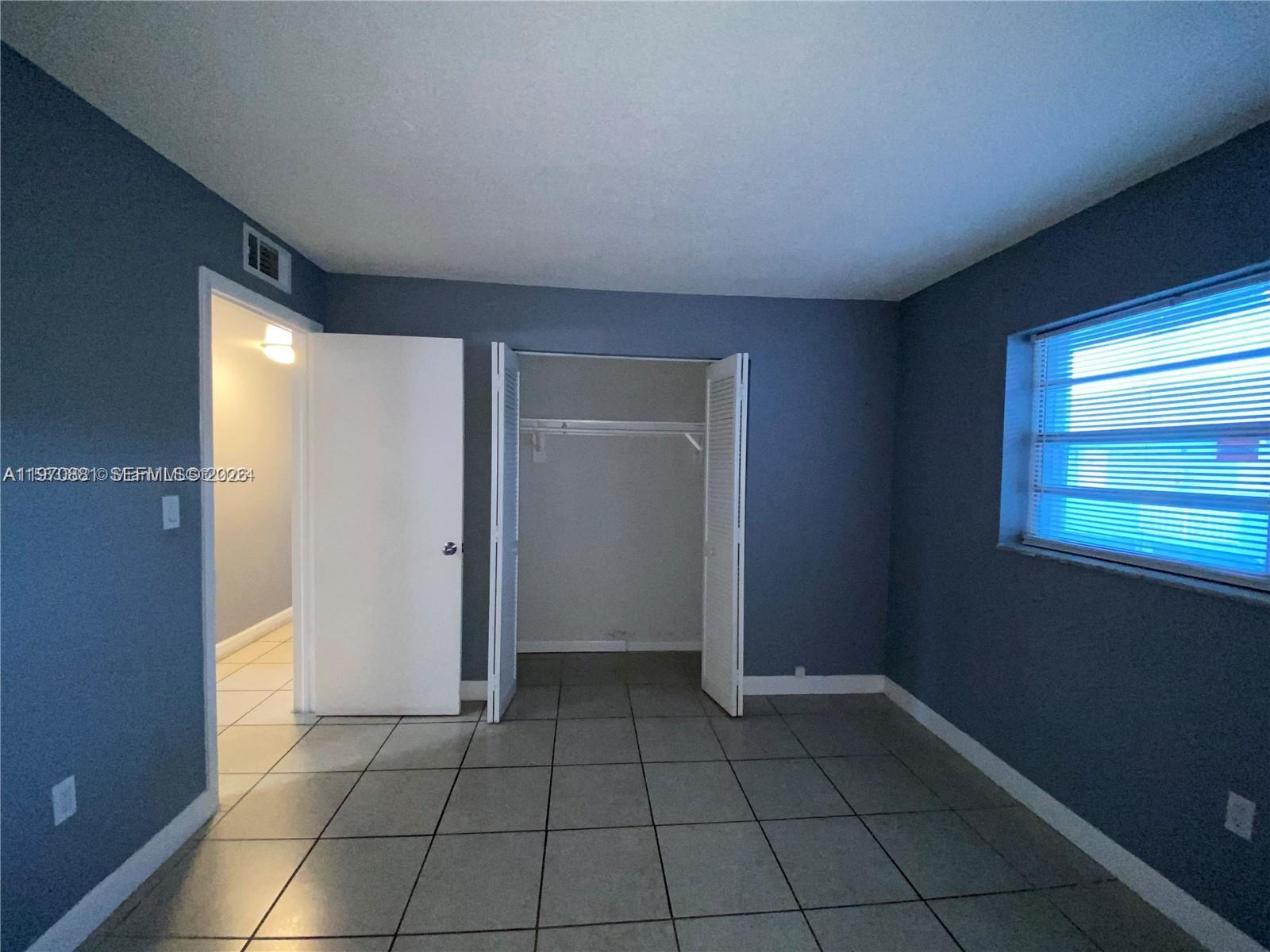 1735 West 60th Street, Unit M301 Hialeah, FL 33012 - Photo 14 of 29 a view of an empty room and window