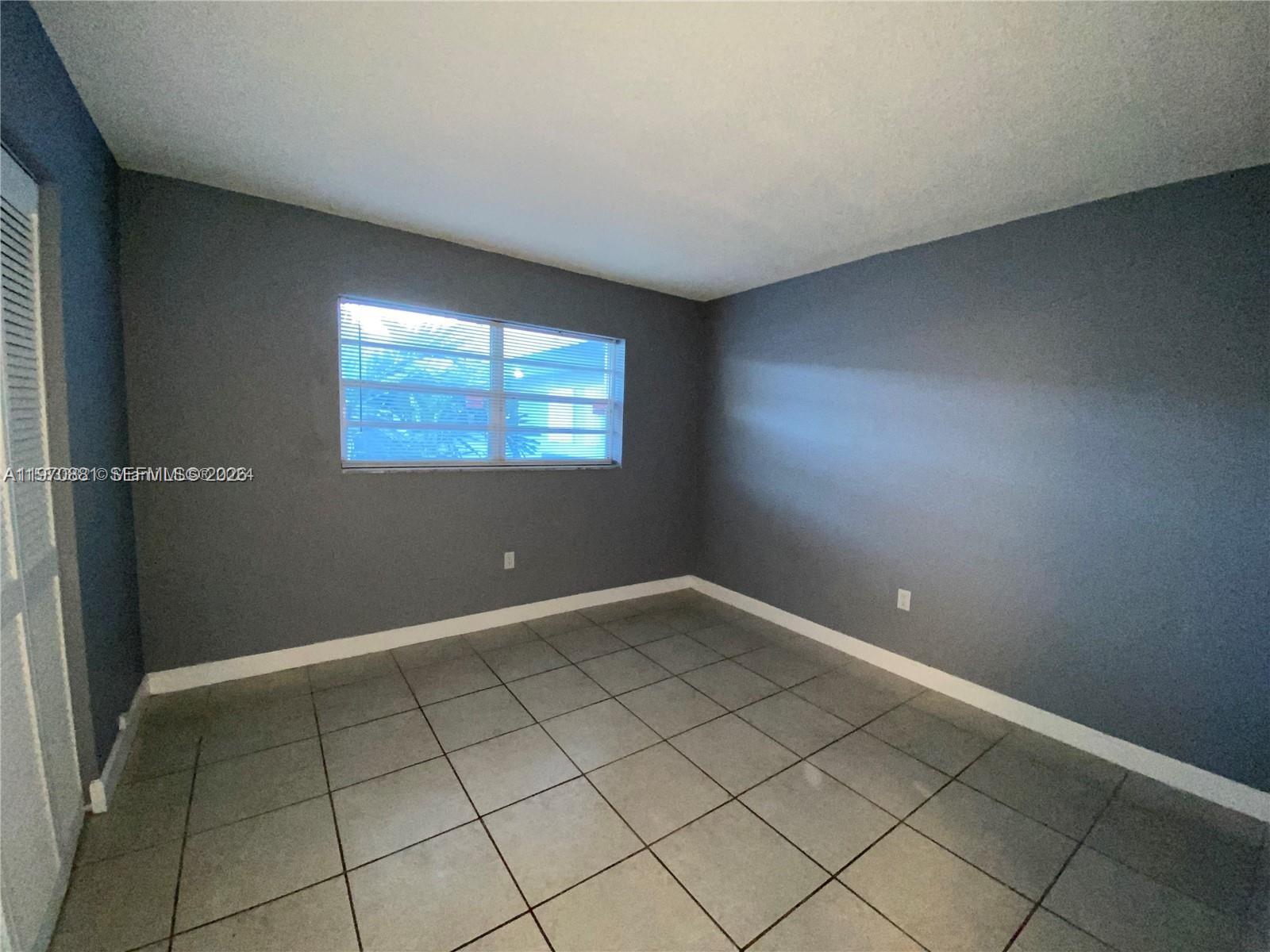 1735 West 60th Street, Unit M301 Hialeah, FL 33012 - Photo 15 of 29 a view of an empty room and window