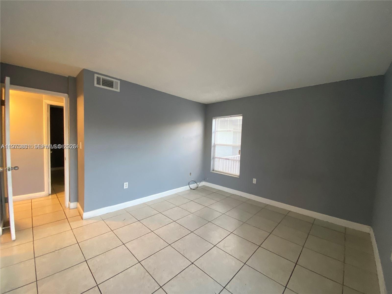 1735 West 60th Street, Unit M301 Hialeah, FL 33012 - Photo 18 of 29 a view of an empty room and window