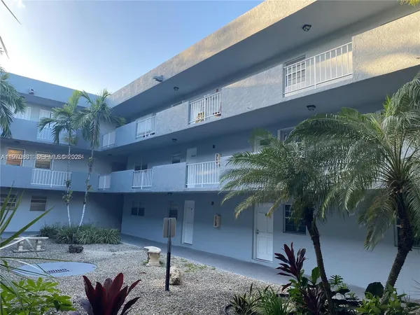 a front view of a house with plants
