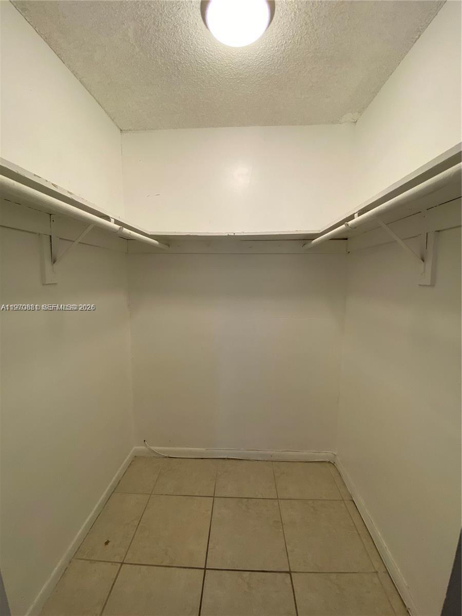 1735 West 60th Street, Unit M301 Hialeah, FL 33012 - Photo 21 of 29 a view of a room with an empty shelf