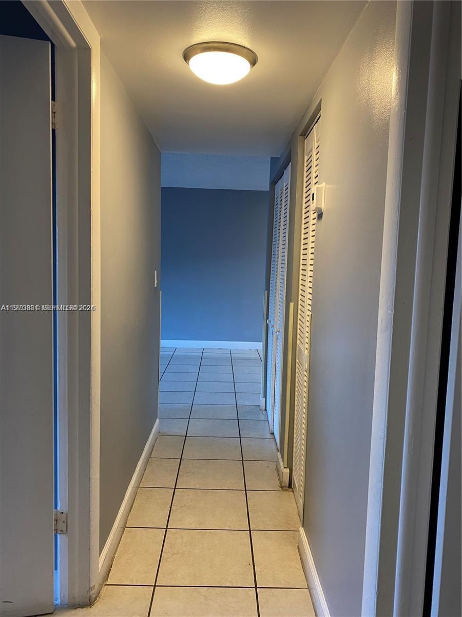 1735 West 60th Street, Unit M301 Hialeah, FL 33012 - Photo 22 of 29 a view of a hallway