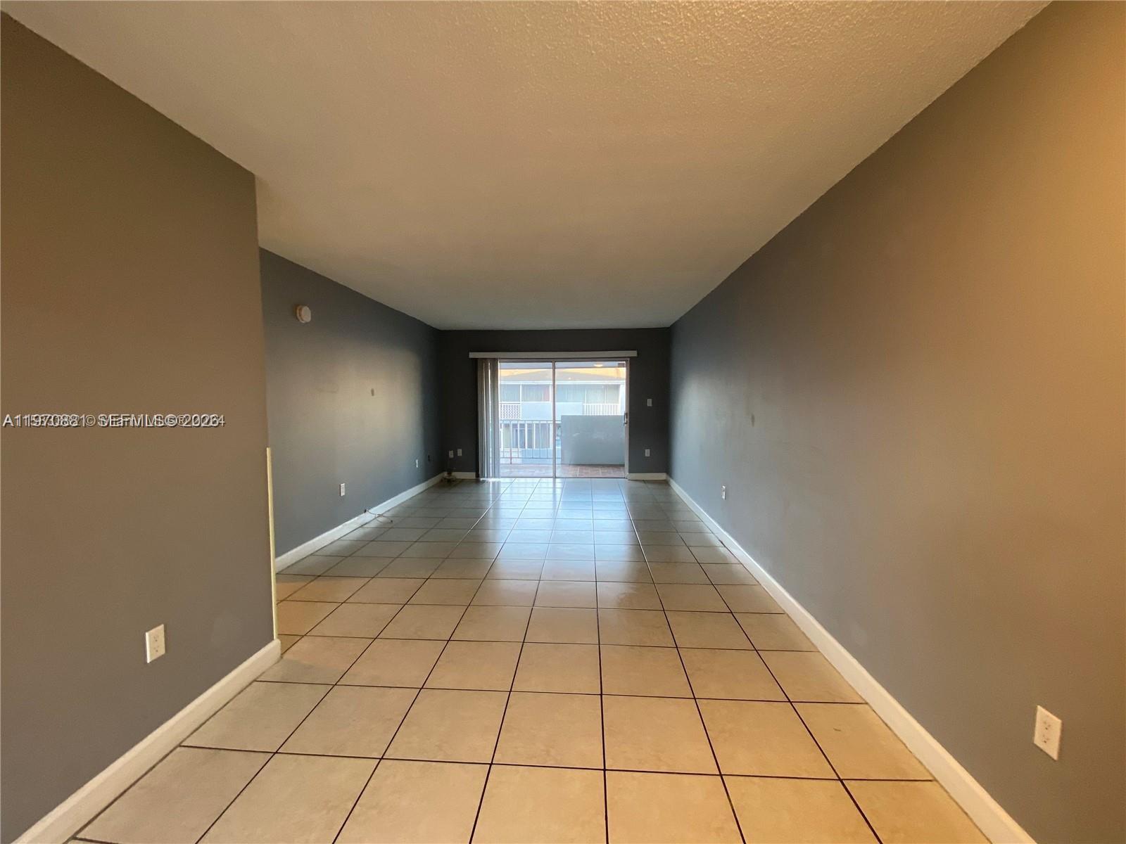 1735 West 60th Street, Unit M301 Hialeah, FL 33012 - Photo 7 of 29 a view of an empty room and window