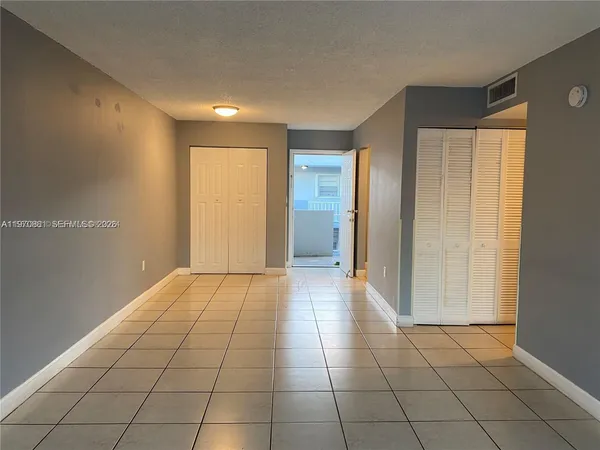 a view of a livingroom with an empty space and a window
