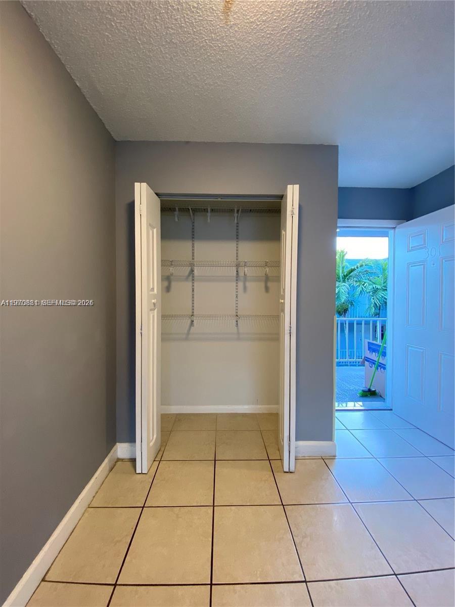 1735 West 60th Street, Unit M301 Hialeah, FL 33012 - Photo 10 of 29 an empty room with windows