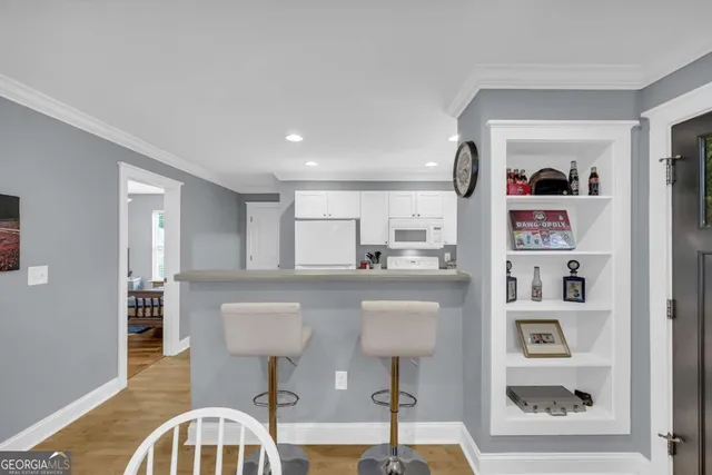 a living room with furniture and a book shelf
