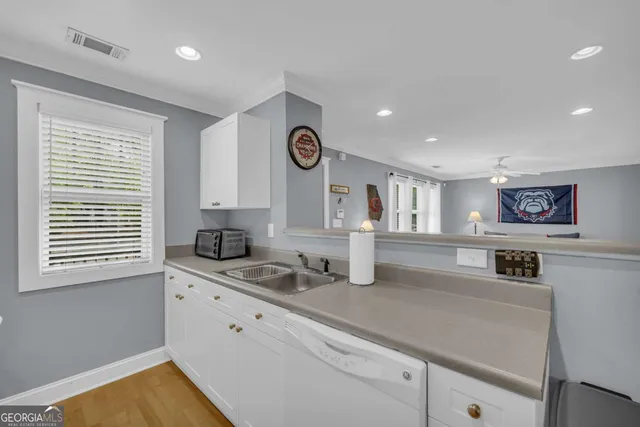 a kitchen with stainless steel appliances granite countertop a sink and a stove