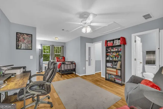 a view of a livingroom with furniture and gym equipment