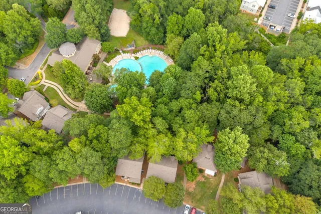 an aerial view of a house with a yard and outdoor seating