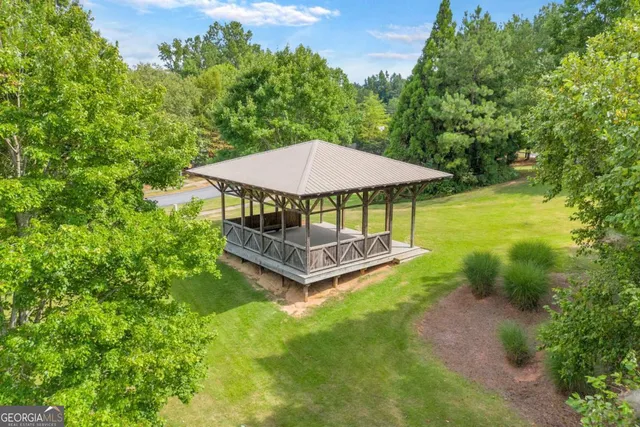 a view of a patio with a table and chairs under an umbrella
