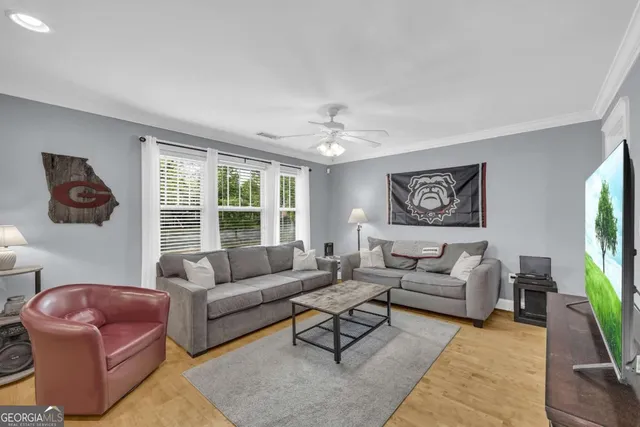 a living room with furniture and a flat screen tv