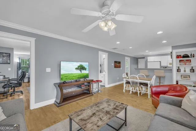 a living room with furniture and a flat screen tv