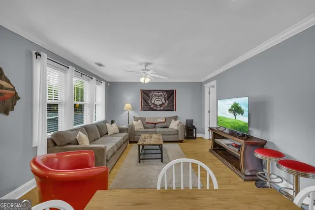a living room with furniture and a flat screen tv
