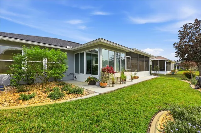 an aerial view of a house with a swimming pool yard and outdoor seating